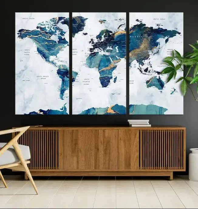 The modern living room showcases the Blue Green World Map Wall Art Canvas Print, a captivating three-panel artwork crafted on museum-quality canvases with a UV-protective coating.