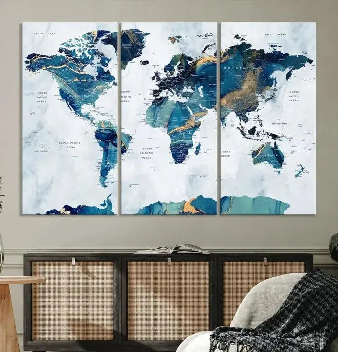 The modern living room showcases the Blue Green World Map Wall Art Canvas Print, a captivating three-panel artwork crafted on museum-quality canvases with a UV-protective coating.