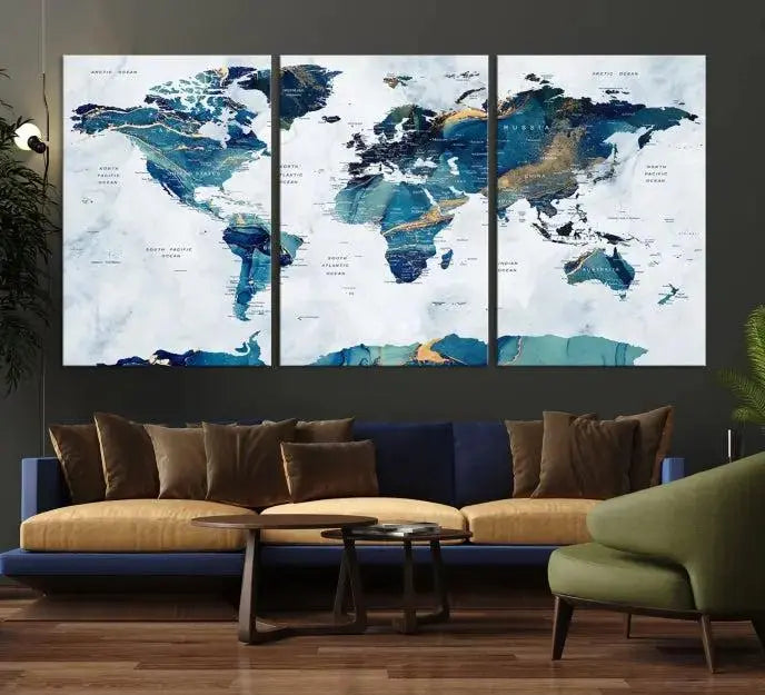 The modern living room showcases the Blue Green World Map Wall Art Canvas Print, a captivating three-panel artwork crafted on museum-quality canvases with a UV-protective coating.