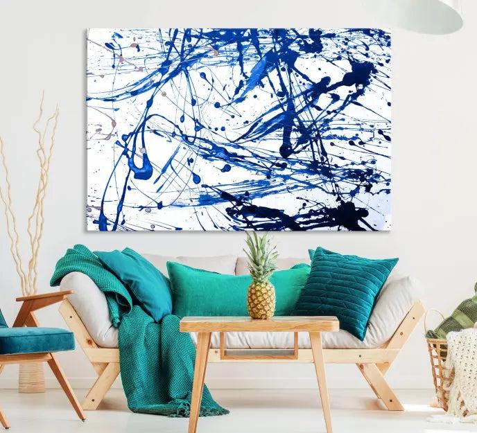 The Blue Ink Splash Wall Art Canvas Print Success is a triptych abstract piece featuring blue splatters on a clean white background. Crafted on gallery-wrapped canvases of museum quality, it includes a UV-protective coating to maintain its vibrant allure for years.