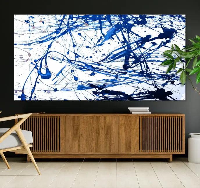 The Blue Ink Splash Wall Art Canvas Print Success is a triptych abstract piece featuring blue splatters on a clean white background. Crafted on gallery-wrapped canvases of museum quality, it includes a UV-protective coating to maintain its vibrant allure for years.