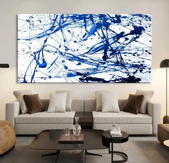 The Blue Ink Splash Wall Art Canvas Print Success is a triptych abstract piece featuring blue splatters on a clean white background. Crafted on gallery-wrapped canvases of museum quality, it includes a UV-protective coating to maintain its vibrant allure for years.