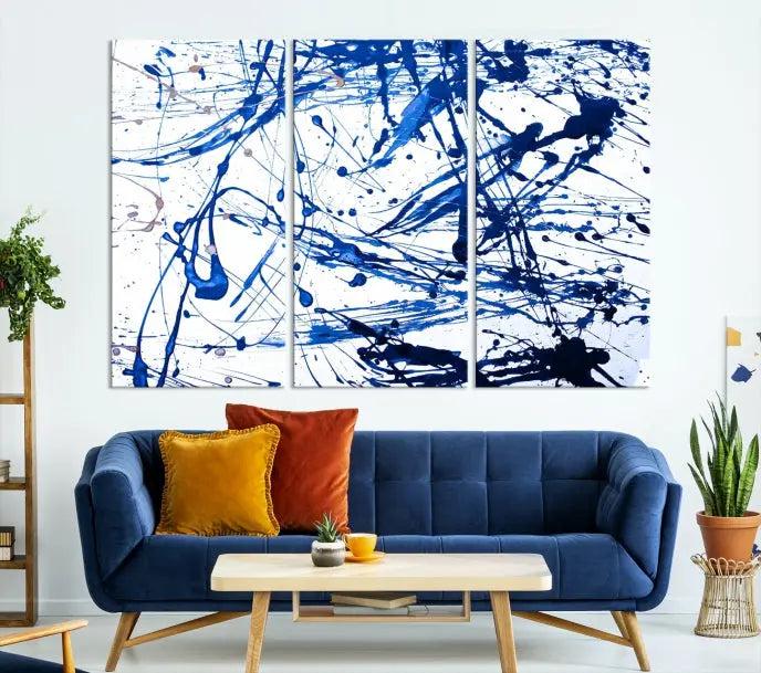 The Blue Ink Splash Wall Art Canvas Print Success is a triptych abstract piece featuring blue splatters on a clean white background. Crafted on gallery-wrapped canvases of museum quality, it includes a UV-protective coating to maintain its vibrant allure for years.