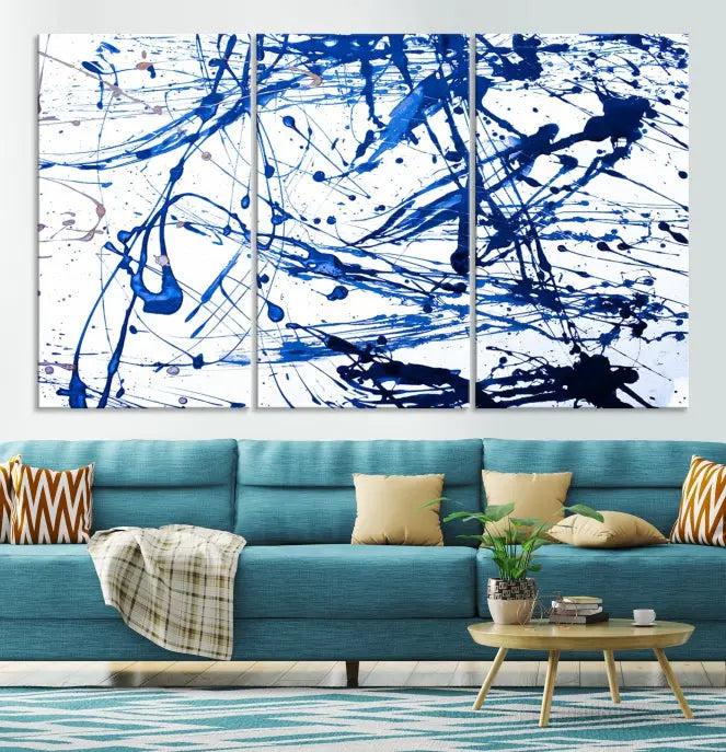 The Blue Ink Splash Wall Art Canvas Print Success is a triptych abstract piece featuring blue splatters on a clean white background. Crafted on gallery-wrapped canvases of museum quality, it includes a UV-protective coating to maintain its vibrant allure for years.