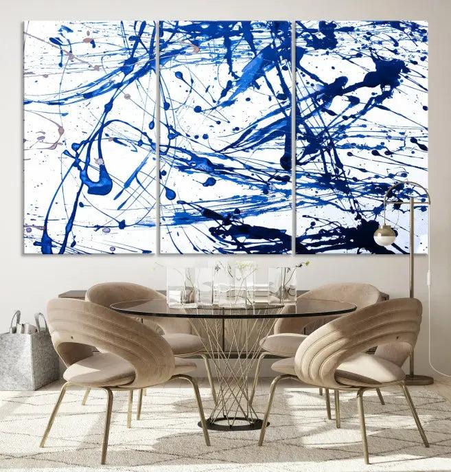 The Blue Ink Splash Wall Art Canvas Print Success is a triptych abstract piece featuring blue splatters on a clean white background. Crafted on gallery-wrapped canvases of museum quality, it includes a UV-protective coating to maintain its vibrant allure for years.