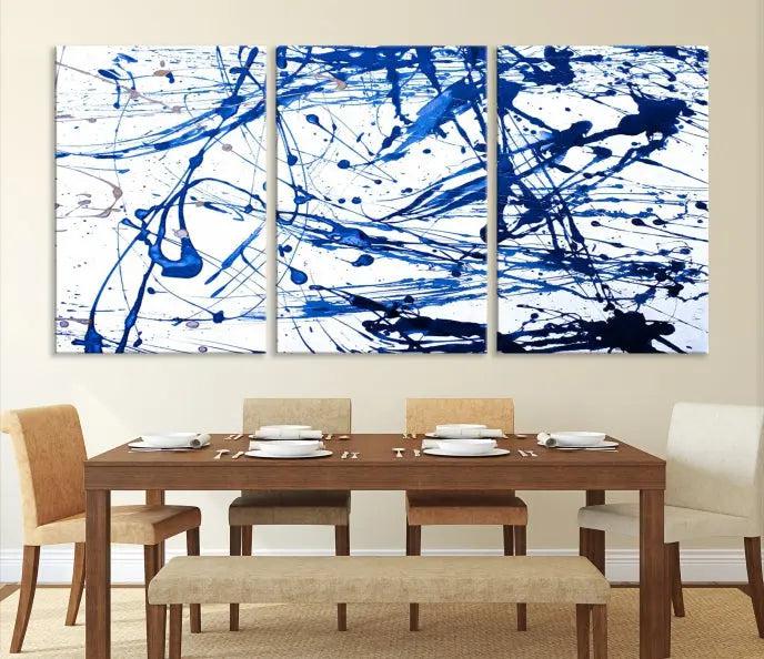 The Blue Ink Splash Wall Art Canvas Print Success is a triptych abstract piece featuring blue splatters on a clean white background. Crafted on gallery-wrapped canvases of museum quality, it includes a UV-protective coating to maintain its vibrant allure for years.