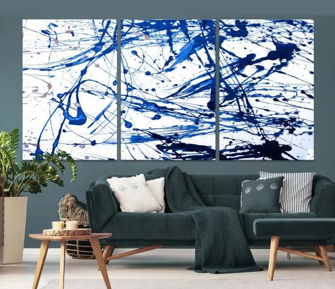 The Blue Ink Splash Wall Art Canvas Print Success is a triptych abstract piece featuring blue splatters on a clean white background. Crafted on gallery-wrapped canvases of museum quality, it includes a UV-protective coating to maintain its vibrant allure for years.