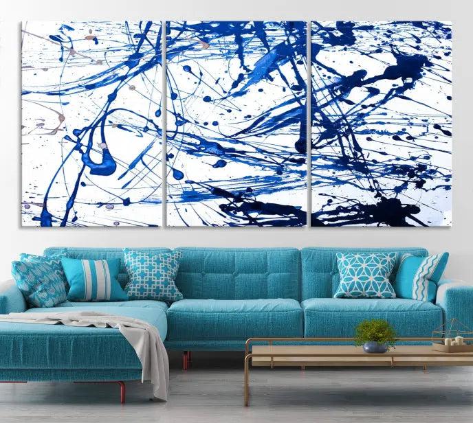 The Blue Ink Splash Wall Art Canvas Print Success is a triptych abstract piece featuring blue splatters on a clean white background. Crafted on gallery-wrapped canvases of museum quality, it includes a UV-protective coating to maintain its vibrant allure for years.