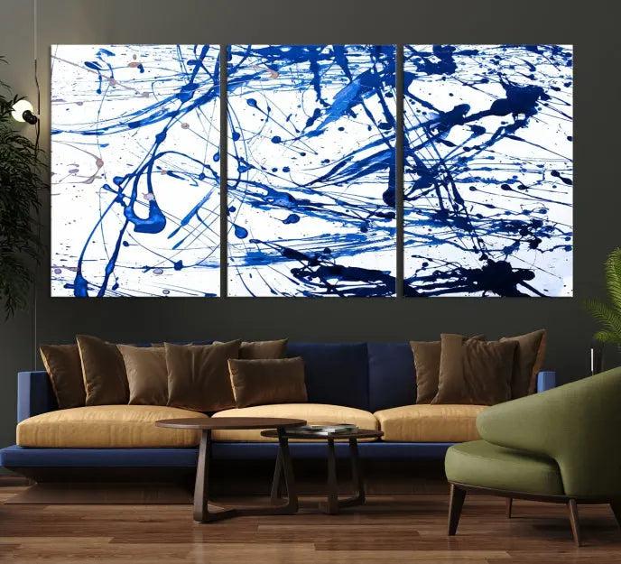 The Blue Ink Splash Wall Art Canvas Print Success is a triptych abstract piece featuring blue splatters on a clean white background. Crafted on gallery-wrapped canvases of museum quality, it includes a UV-protective coating to maintain its vibrant allure for years.