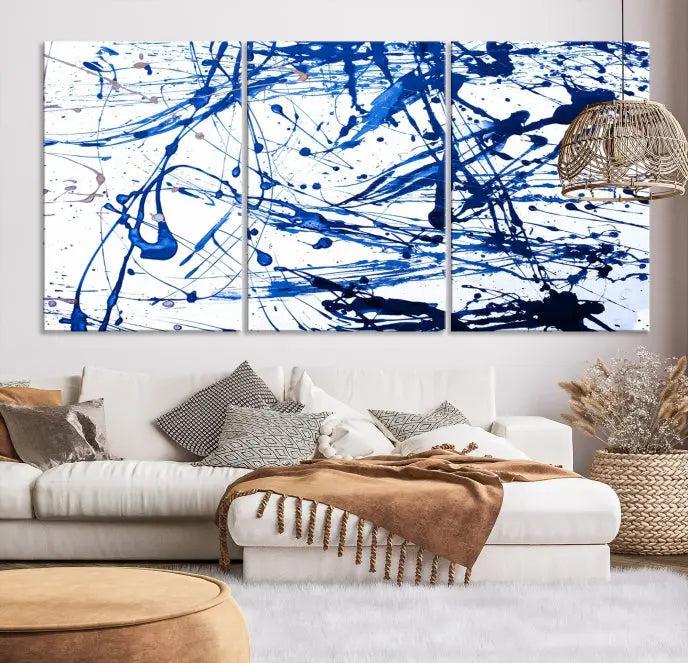 The Blue Ink Splash Wall Art Canvas Print Success is a triptych abstract piece featuring blue splatters on a clean white background. Crafted on gallery-wrapped canvases of museum quality, it includes a UV-protective coating to maintain its vibrant allure for years.