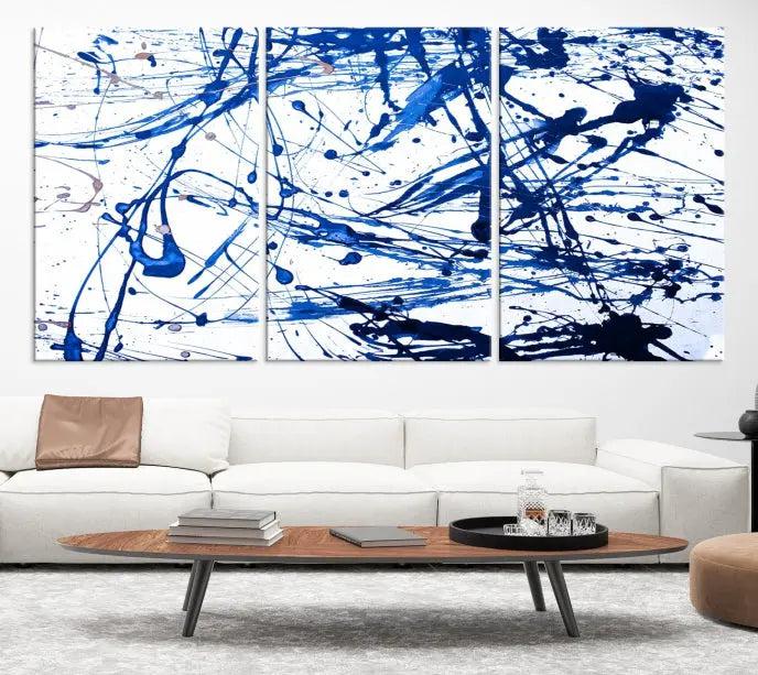 The Blue Ink Splash Wall Art Canvas Print Success is a triptych abstract piece featuring blue splatters on a clean white background. Crafted on gallery-wrapped canvases of museum quality, it includes a UV-protective coating to maintain its vibrant allure for years.