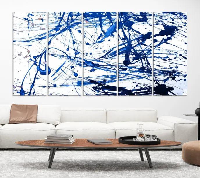 The Blue Ink Splash Wall Art Canvas Print Success is a triptych abstract piece featuring blue splatters on a clean white background. Crafted on gallery-wrapped canvases of museum quality, it includes a UV-protective coating to maintain its vibrant allure for years.