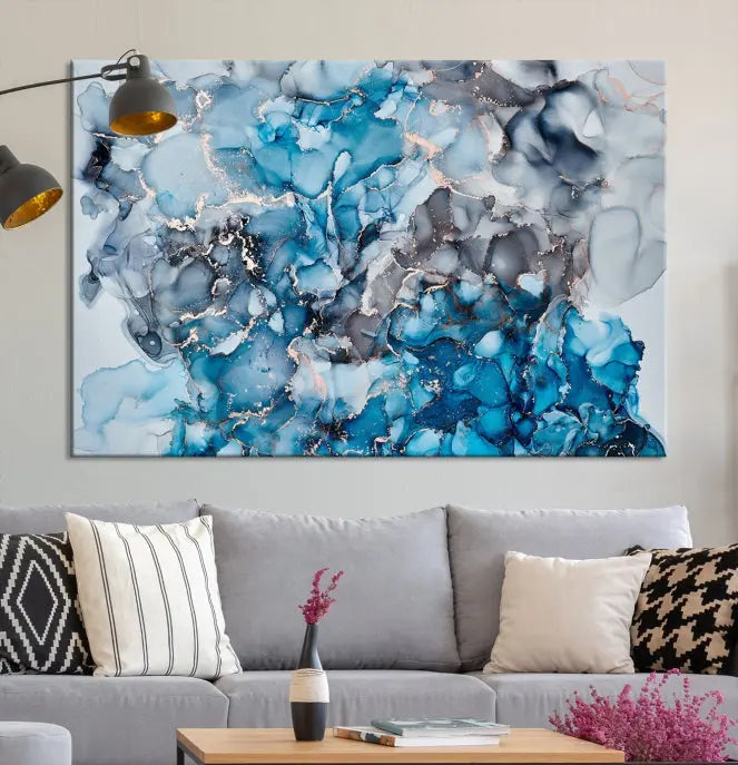 The "Blue Marble Fluid Effect Wall Art Abstract Canvas Wall Art Print" is a triptych that showcases captivating blue and gray abstract patterns on museum-quality canvas. It is enhanced with a UV-protective coating to maintain its vivid colors over time.