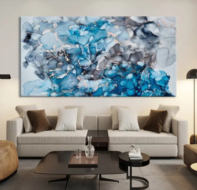 The "Blue Marble Fluid Effect Wall Art Abstract Canvas Wall Art Print" is a triptych that showcases captivating blue and gray abstract patterns on museum-quality canvas. It is enhanced with a UV-protective coating to maintain its vivid colors over time.