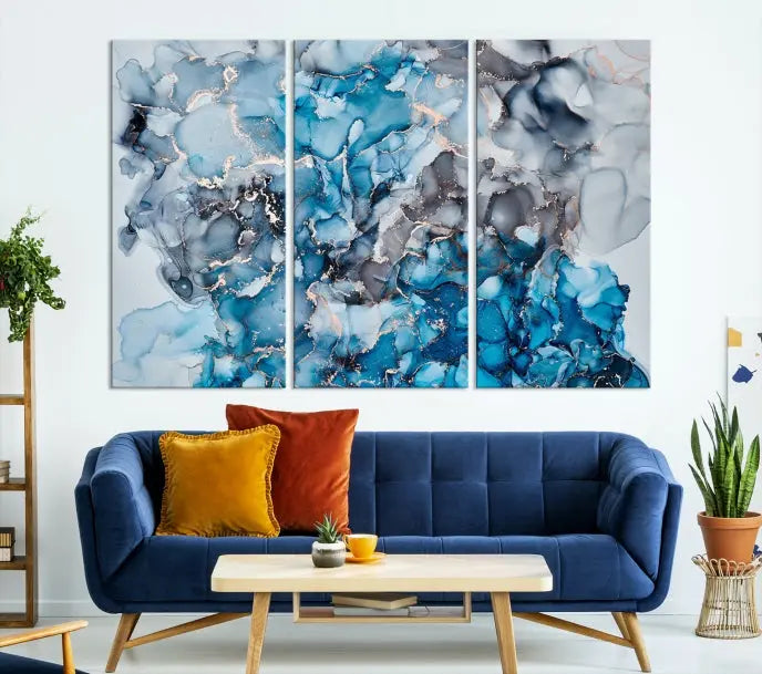 The "Blue Marble Fluid Effect Wall Art Abstract Canvas Wall Art Print" is a triptych that showcases captivating blue and gray abstract patterns on museum-quality canvas. It is enhanced with a UV-protective coating to maintain its vivid colors over time.