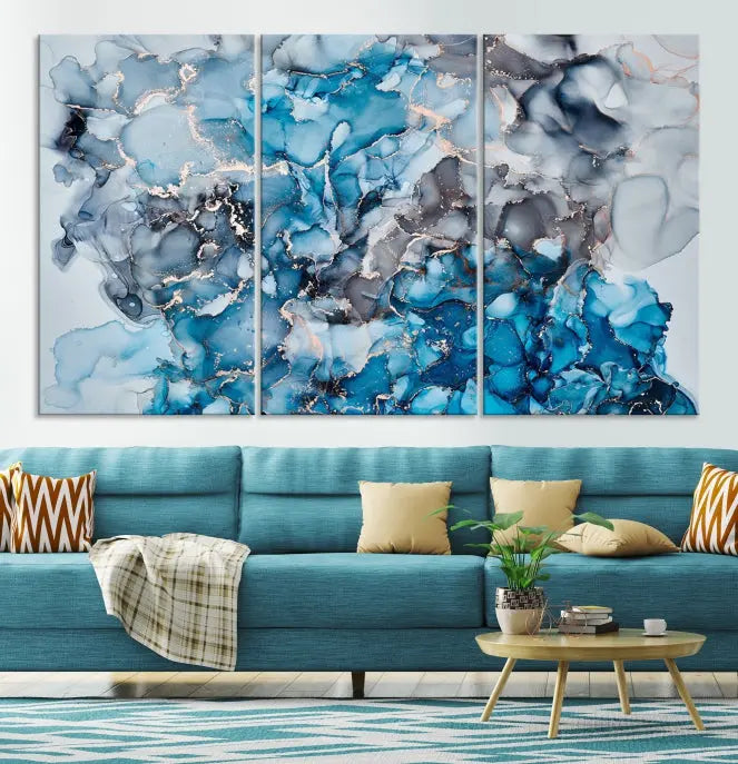 The "Blue Marble Fluid Effect Wall Art Abstract Canvas Wall Art Print" is a triptych that showcases captivating blue and gray abstract patterns on museum-quality canvas. It is enhanced with a UV-protective coating to maintain its vivid colors over time.