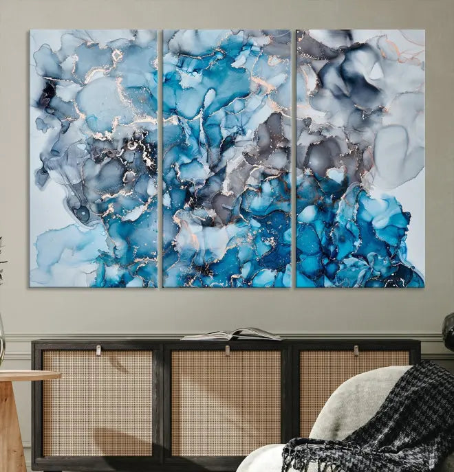 The "Blue Marble Fluid Effect Wall Art Abstract Canvas Wall Art Print" is a triptych that showcases captivating blue and gray abstract patterns on museum-quality canvas. It is enhanced with a UV-protective coating to maintain its vivid colors over time.