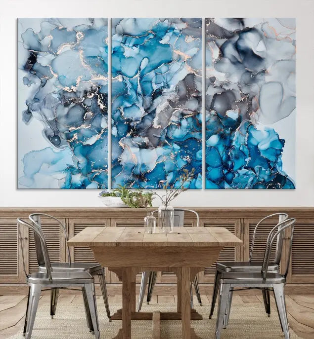 The "Blue Marble Fluid Effect Wall Art Abstract Canvas Wall Art Print" is a triptych that showcases captivating blue and gray abstract patterns on museum-quality canvas. It is enhanced with a UV-protective coating to maintain its vivid colors over time.