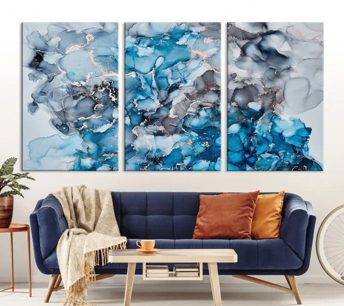 The "Blue Marble Fluid Effect Wall Art Abstract Canvas Wall Art Print" is a triptych that showcases captivating blue and gray abstract patterns on museum-quality canvas. It is enhanced with a UV-protective coating to maintain its vivid colors over time.