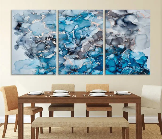 The "Blue Marble Fluid Effect Wall Art Abstract Canvas Wall Art Print" is a triptych that showcases captivating blue and gray abstract patterns on museum-quality canvas. It is enhanced with a UV-protective coating to maintain its vivid colors over time.