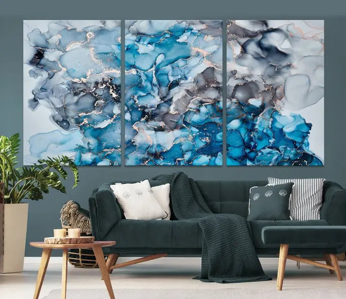 The "Blue Marble Fluid Effect Wall Art Abstract Canvas Wall Art Print" is a triptych that showcases captivating blue and gray abstract patterns on museum-quality canvas. It is enhanced with a UV-protective coating to maintain its vivid colors over time.