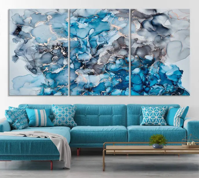 The "Blue Marble Fluid Effect Wall Art Abstract Canvas Wall Art Print" is a triptych that showcases captivating blue and gray abstract patterns on museum-quality canvas. It is enhanced with a UV-protective coating to maintain its vivid colors over time.