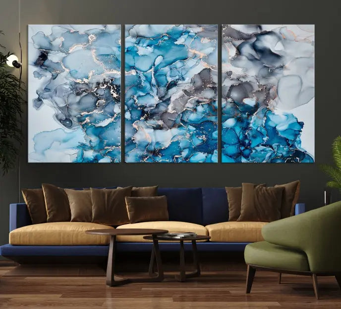 The "Blue Marble Fluid Effect Wall Art Abstract Canvas Wall Art Print" is a triptych that showcases captivating blue and gray abstract patterns on museum-quality canvas. It is enhanced with a UV-protective coating to maintain its vivid colors over time.