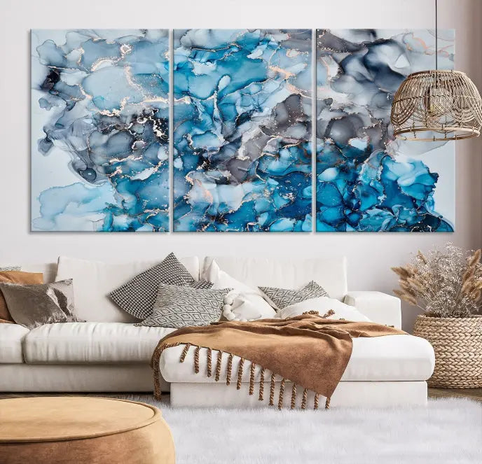 The "Blue Marble Fluid Effect Wall Art Abstract Canvas Wall Art Print" is a triptych that showcases captivating blue and gray abstract patterns on museum-quality canvas. It is enhanced with a UV-protective coating to maintain its vivid colors over time.