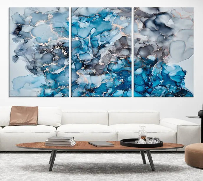 The "Blue Marble Fluid Effect Wall Art Abstract Canvas Wall Art Print" is a triptych that showcases captivating blue and gray abstract patterns on museum-quality canvas. It is enhanced with a UV-protective coating to maintain its vivid colors over time.