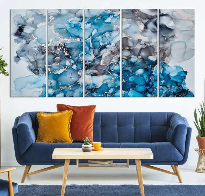 The "Blue Marble Fluid Effect Wall Art Abstract Canvas Wall Art Print" is a triptych that showcases captivating blue and gray abstract patterns on museum-quality canvas. It is enhanced with a UV-protective coating to maintain its vivid colors over time.