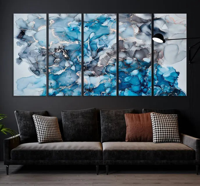 The "Blue Marble Fluid Effect Wall Art Abstract Canvas Wall Art Print" is a triptych that showcases captivating blue and gray abstract patterns on museum-quality canvas. It is enhanced with a UV-protective coating to maintain its vivid colors over time.