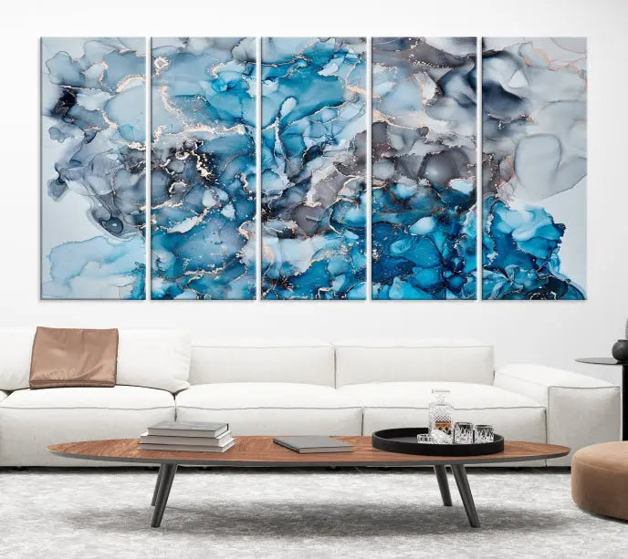 The "Blue Marble Fluid Effect Wall Art Abstract Canvas Wall Art Print" is a triptych that showcases captivating blue and gray abstract patterns on museum-quality canvas. It is enhanced with a UV-protective coating to maintain its vivid colors over time.