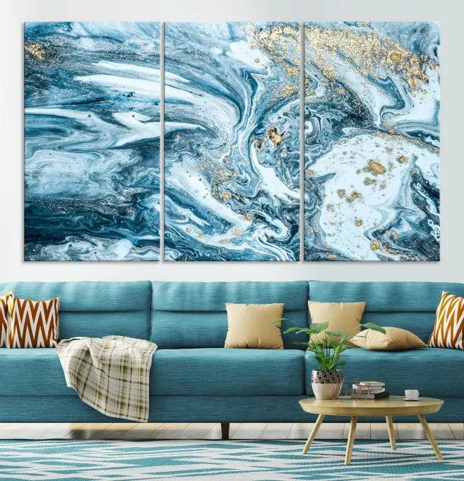 A triptych piece titled "Blue Marble Fluid Effect Wall Art Canvas Wall Art Print," featuring an abstract design in blue and gold on museum-quality canvas with a UV-protective coating, graces the wall.