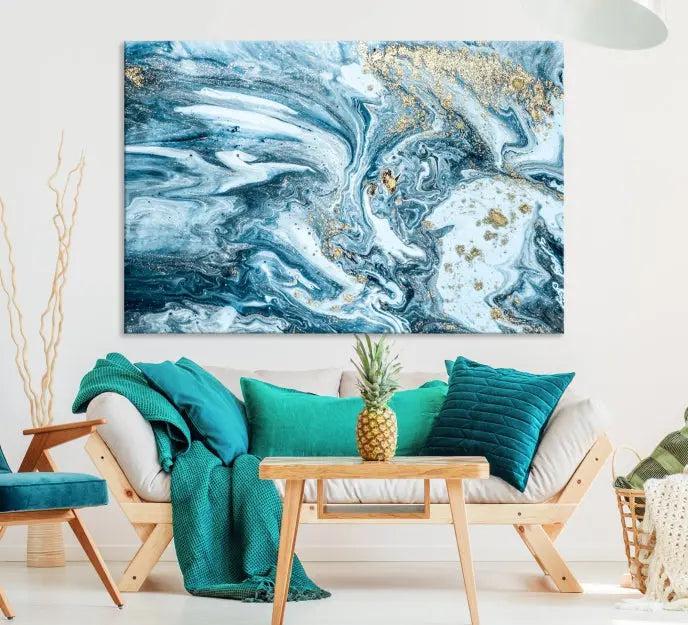 A triptych piece titled "Blue Marble Fluid Effect Wall Art Canvas Wall Art Print," featuring an abstract design in blue and gold on museum-quality canvas with a UV-protective coating, graces the wall.