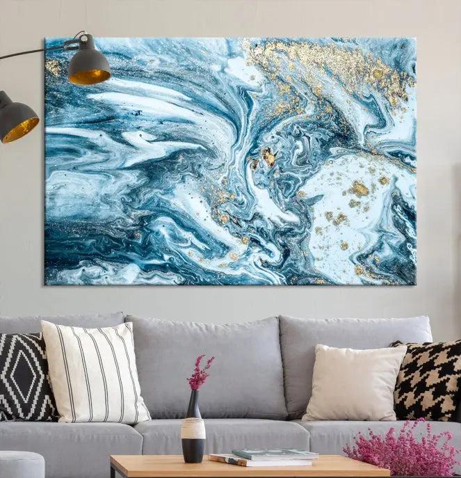 A triptych piece titled "Blue Marble Fluid Effect Wall Art Canvas Wall Art Print," featuring an abstract design in blue and gold on museum-quality canvas with a UV-protective coating, graces the wall.