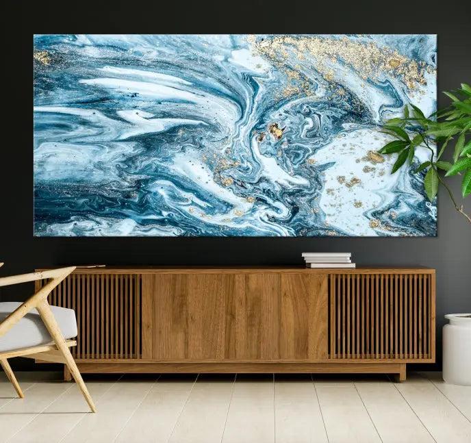 A triptych piece titled "Blue Marble Fluid Effect Wall Art Canvas Wall Art Print," featuring an abstract design in blue and gold on museum-quality canvas with a UV-protective coating, graces the wall.