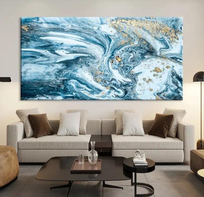 A triptych piece titled "Blue Marble Fluid Effect Wall Art Canvas Wall Art Print," featuring an abstract design in blue and gold on museum-quality canvas with a UV-protective coating, graces the wall.