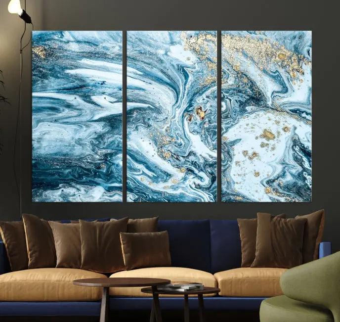 A triptych piece titled "Blue Marble Fluid Effect Wall Art Canvas Wall Art Print," featuring an abstract design in blue and gold on museum-quality canvas with a UV-protective coating, graces the wall.