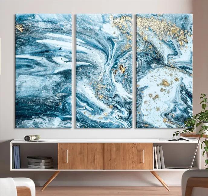 A triptych piece titled "Blue Marble Fluid Effect Wall Art Canvas Wall Art Print," featuring an abstract design in blue and gold on museum-quality canvas with a UV-protective coating, graces the wall.