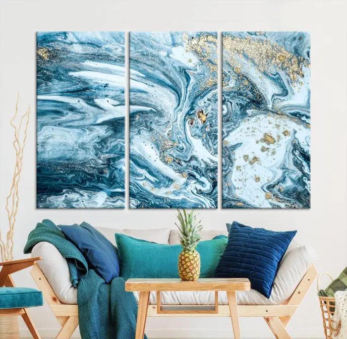 A triptych piece titled "Blue Marble Fluid Effect Wall Art Canvas Wall Art Print," featuring an abstract design in blue and gold on museum-quality canvas with a UV-protective coating, graces the wall.