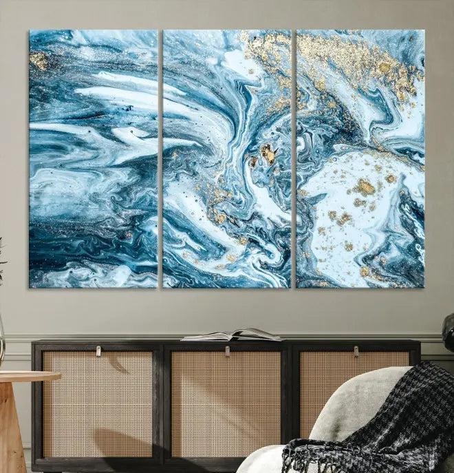 A triptych piece titled "Blue Marble Fluid Effect Wall Art Canvas Wall Art Print," featuring an abstract design in blue and gold on museum-quality canvas with a UV-protective coating, graces the wall.