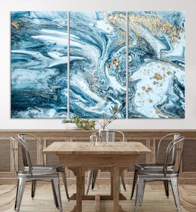 A triptych piece titled "Blue Marble Fluid Effect Wall Art Canvas Wall Art Print," featuring an abstract design in blue and gold on museum-quality canvas with a UV-protective coating, graces the wall.