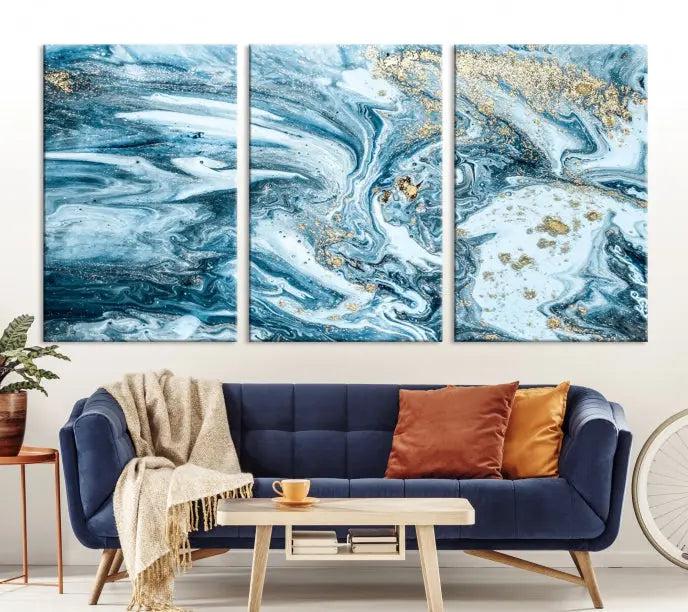 A triptych piece titled "Blue Marble Fluid Effect Wall Art Canvas Wall Art Print," featuring an abstract design in blue and gold on museum-quality canvas with a UV-protective coating, graces the wall.