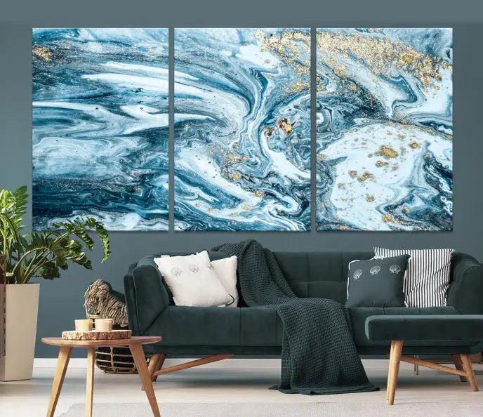 A triptych piece titled "Blue Marble Fluid Effect Wall Art Canvas Wall Art Print," featuring an abstract design in blue and gold on museum-quality canvas with a UV-protective coating, graces the wall.