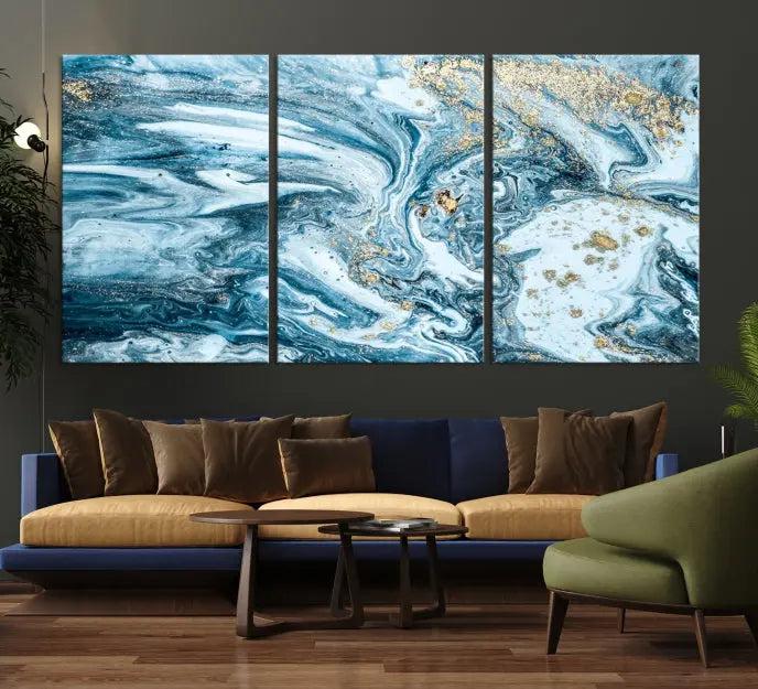 A triptych piece titled "Blue Marble Fluid Effect Wall Art Canvas Wall Art Print," featuring an abstract design in blue and gold on museum-quality canvas with a UV-protective coating, graces the wall.