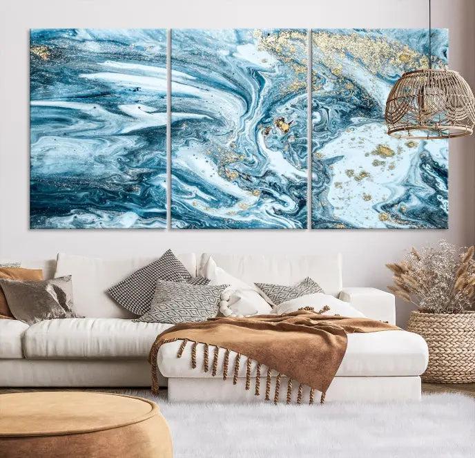 A triptych piece titled "Blue Marble Fluid Effect Wall Art Canvas Wall Art Print," featuring an abstract design in blue and gold on museum-quality canvas with a UV-protective coating, graces the wall.