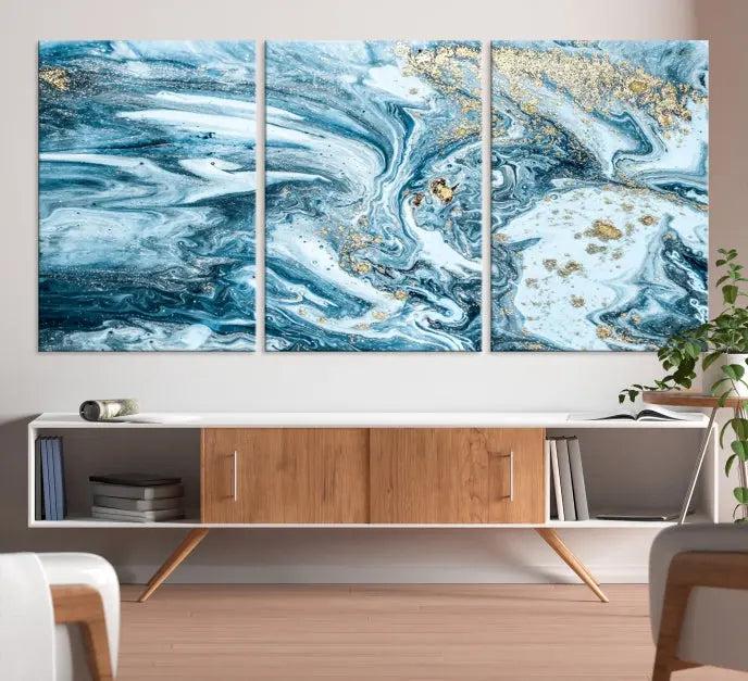 A triptych piece titled "Blue Marble Fluid Effect Wall Art Canvas Wall Art Print," featuring an abstract design in blue and gold on museum-quality canvas with a UV-protective coating, graces the wall.