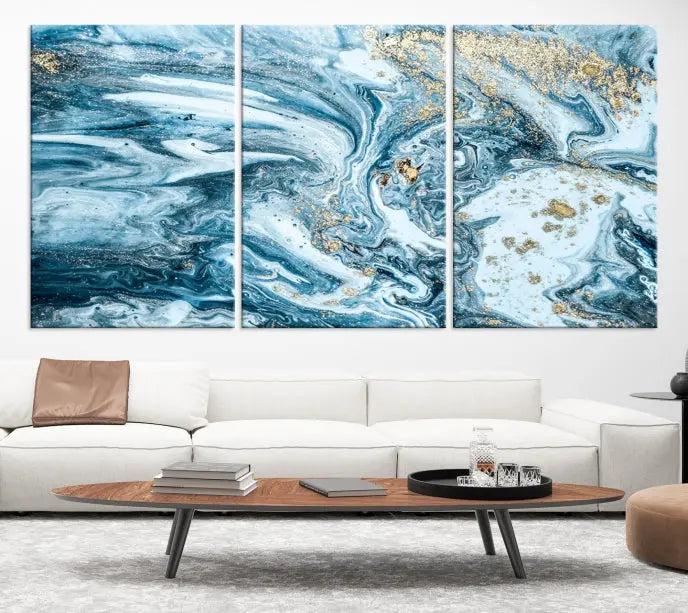 A triptych piece titled "Blue Marble Fluid Effect Wall Art Canvas Wall Art Print," featuring an abstract design in blue and gold on museum-quality canvas with a UV-protective coating, graces the wall.