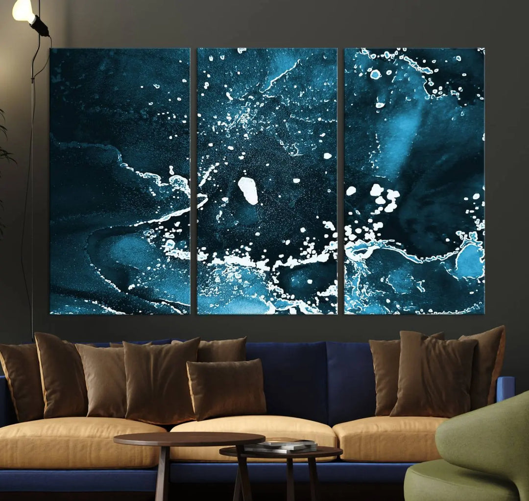 The Blue Marble Ink Splash Effect Wall Art Abstract Canvas Wall Art Print features a gallery-wrapped finish on museum-quality canvas with UV-protective coating, hanging elegantly in the room.