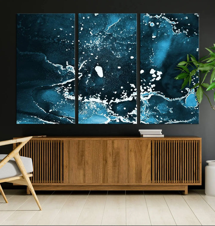 The Blue Marble Ink Splash Effect Wall Art Abstract Canvas Wall Art Print features a gallery-wrapped finish on museum-quality canvas with UV-protective coating, hanging elegantly in the room.